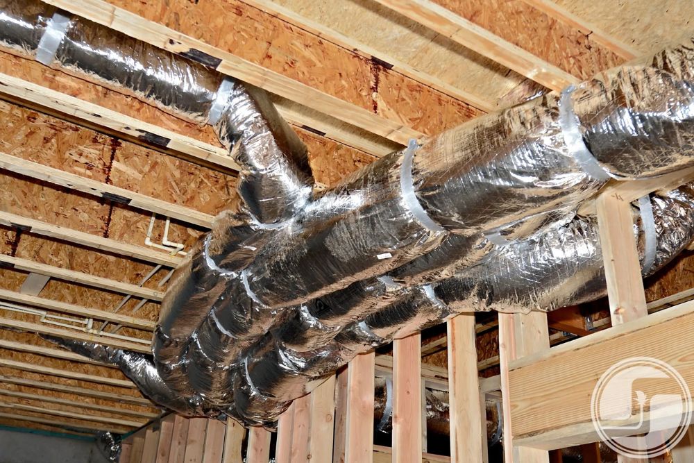 Metal ductwork visible in a home under construction, illustrating the HVAC system setup in an incomplete interior space.