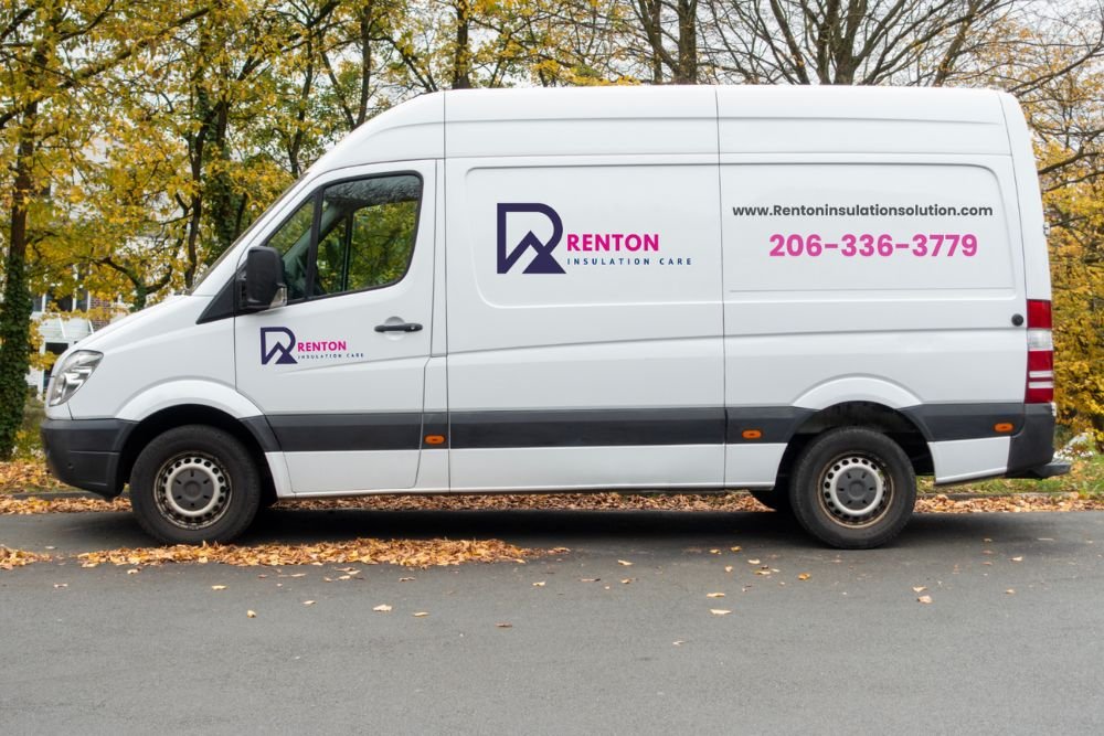 White delivery van with "Renton Restoration" logo and contact information parked on a leafy street.